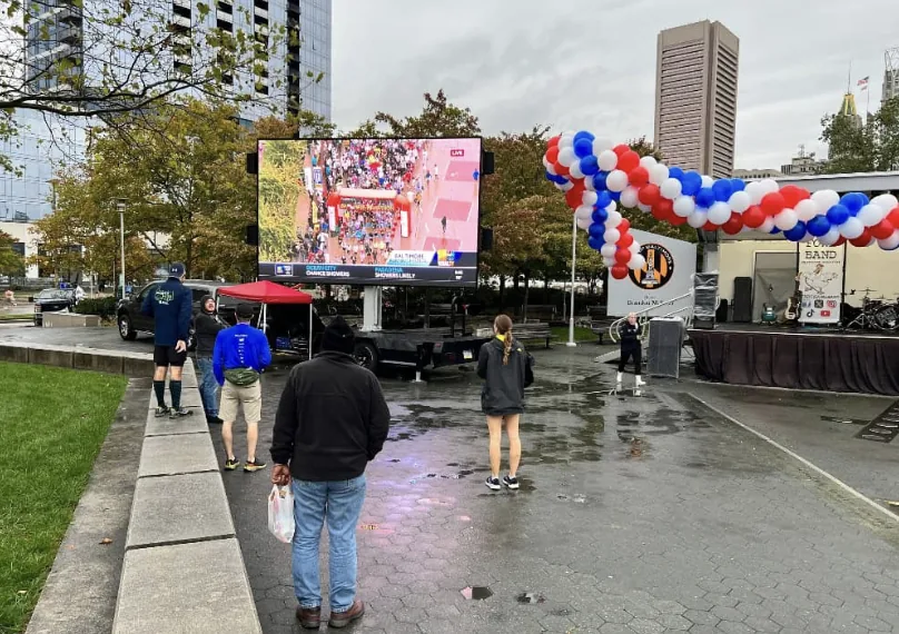 MOBO LED screen trailer at a downtown municipal event on a rainy day