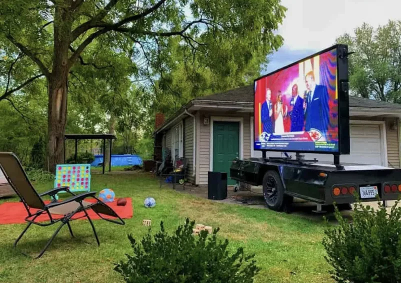 MOBO LED screen trailer set up for a backyard movie night on a residential lawn