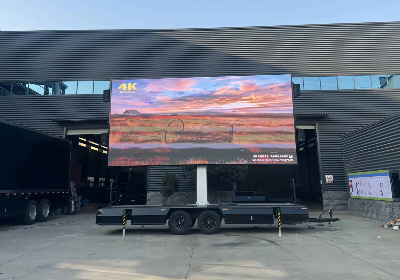 MOBO MB-28 flatbed LED screen trailer with its 23 by 13 foot screen lit