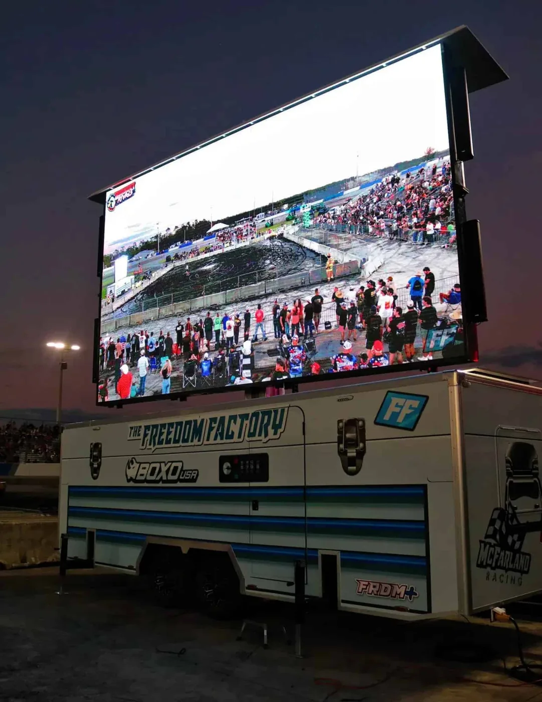 Enclosed MOBO LED screen trailer broadcasting a live car race, same series as the MB-28E