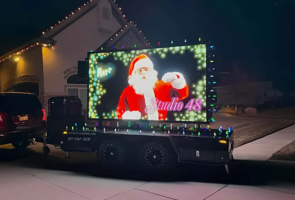 MOBO MB-5D double-sided LED trailer promoting a dance studio with holiday lighting